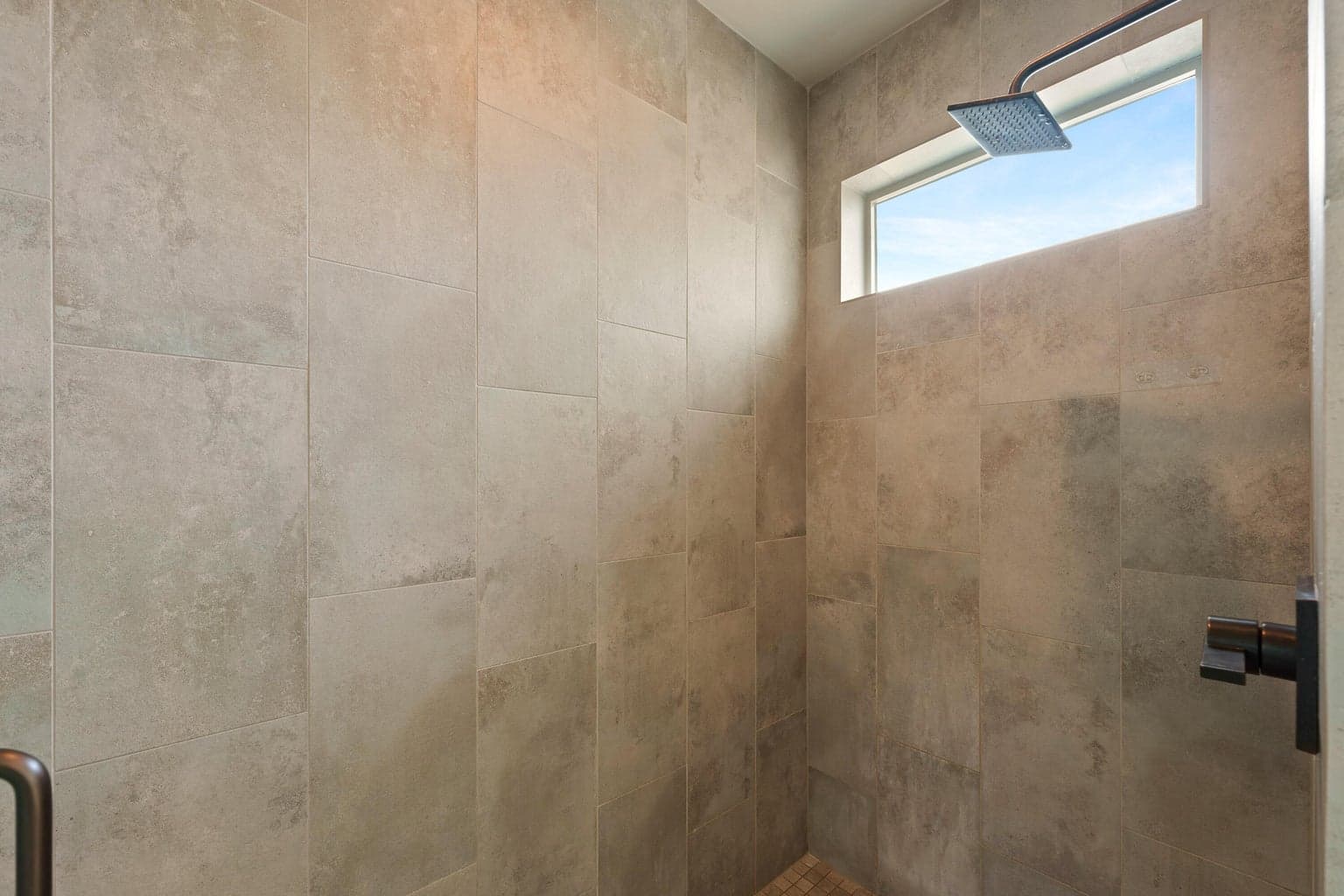 Full height tile shower in primary bathroom