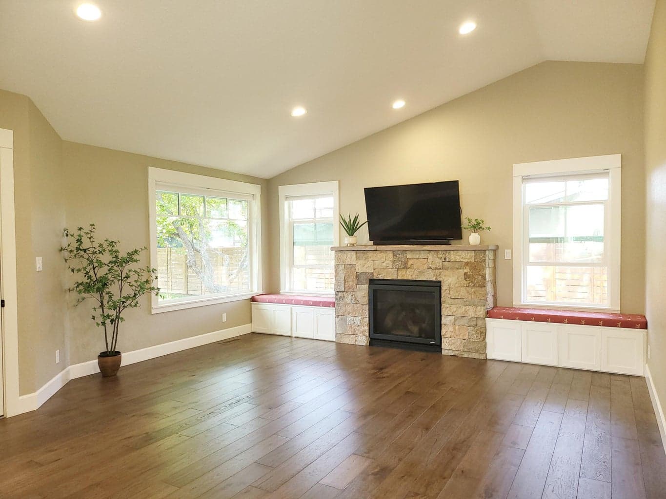 Stone fireplace is gas and features built-in window seating and abundant windows