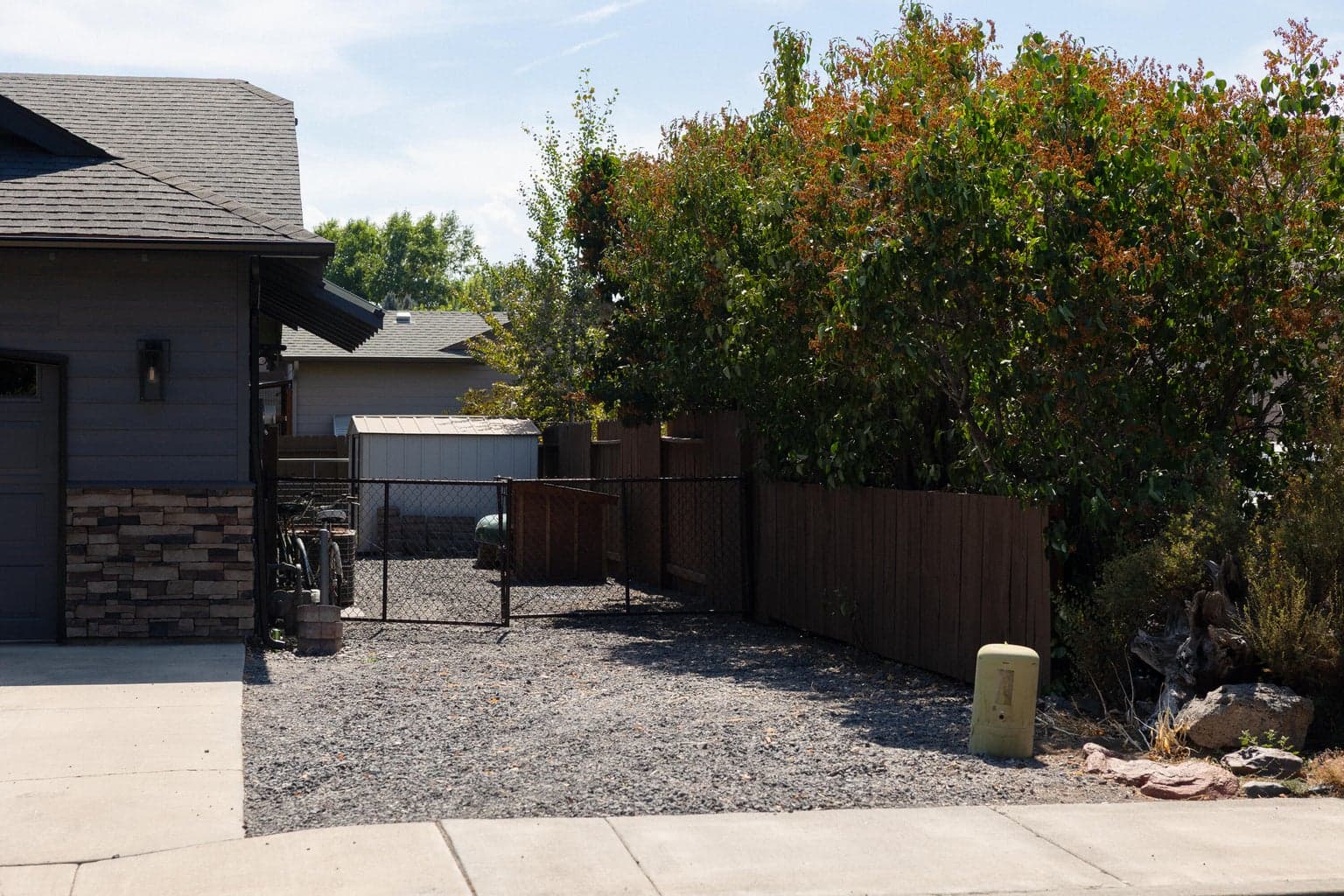 Westside of home with RV and garden shed access