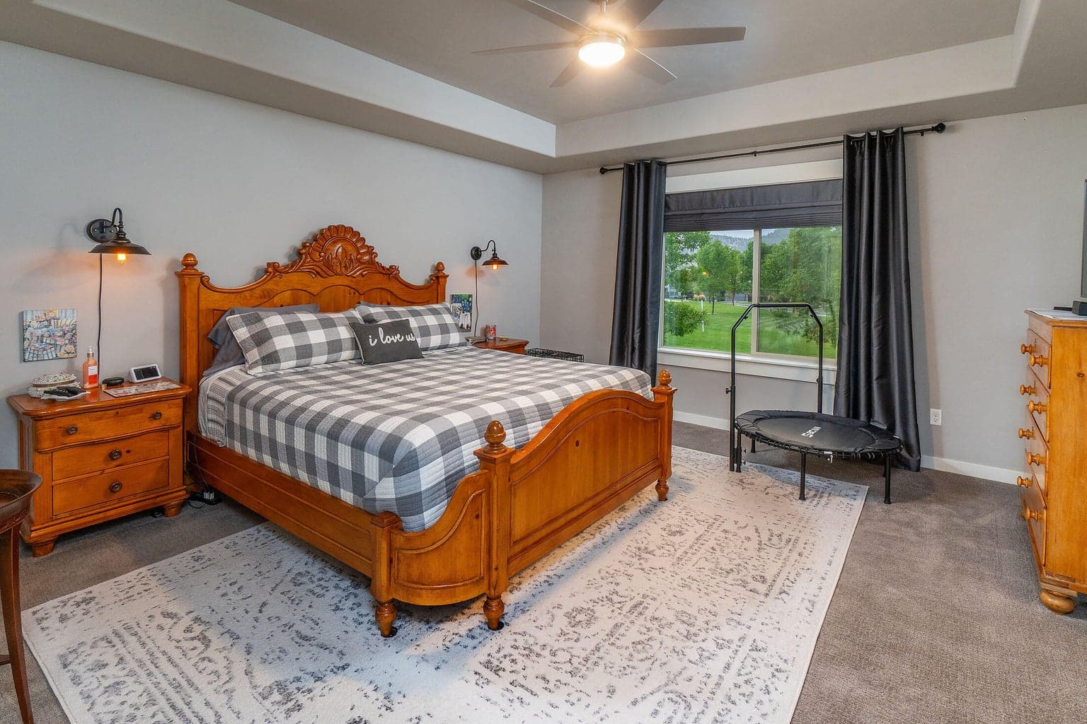Primary suite with coffered ceiling, fan and beautiful park views.