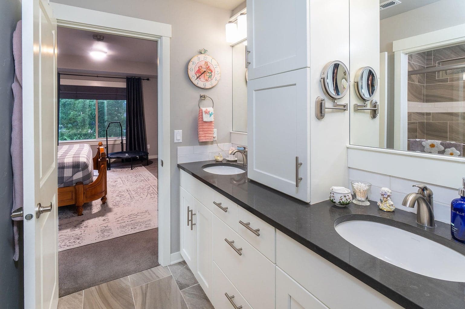 Primary bath has tile shower, tile floors, a wood-wrapped mirror, solar tube for extra light.