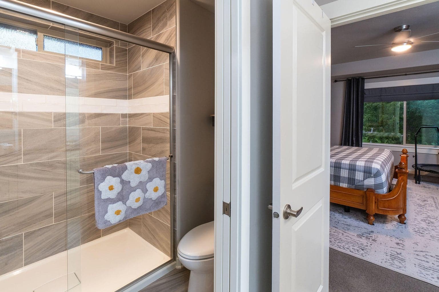Primary bath has tile shower, tile floors, a wood-wrapped mirror, solar tube for extra light.