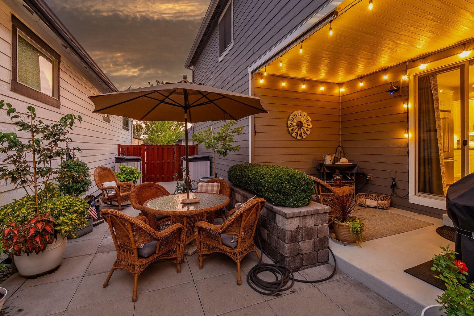 Patio extends throughout the side yard. Covered area and open air.