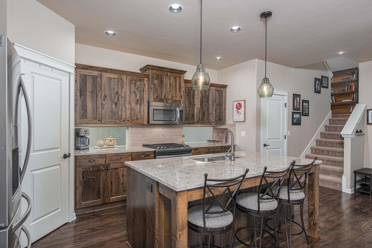 Beautiful bright kitchen with stainless steel appliances, quartz countertops and spacious pantry