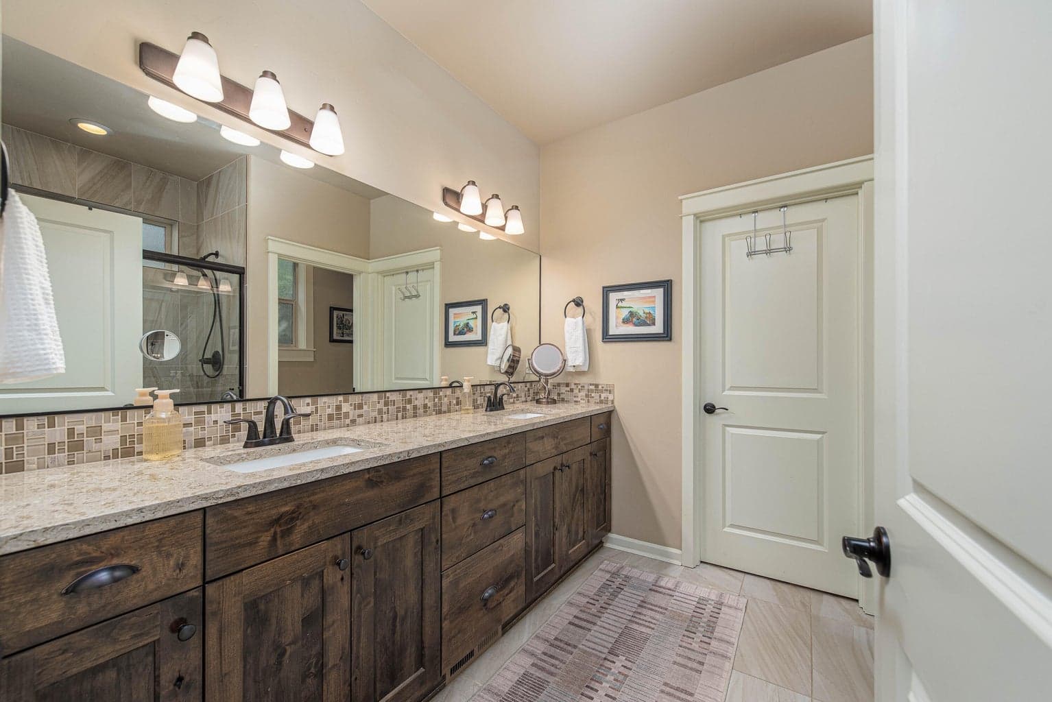 Double sinks with quartz countertops in the primary bathroom