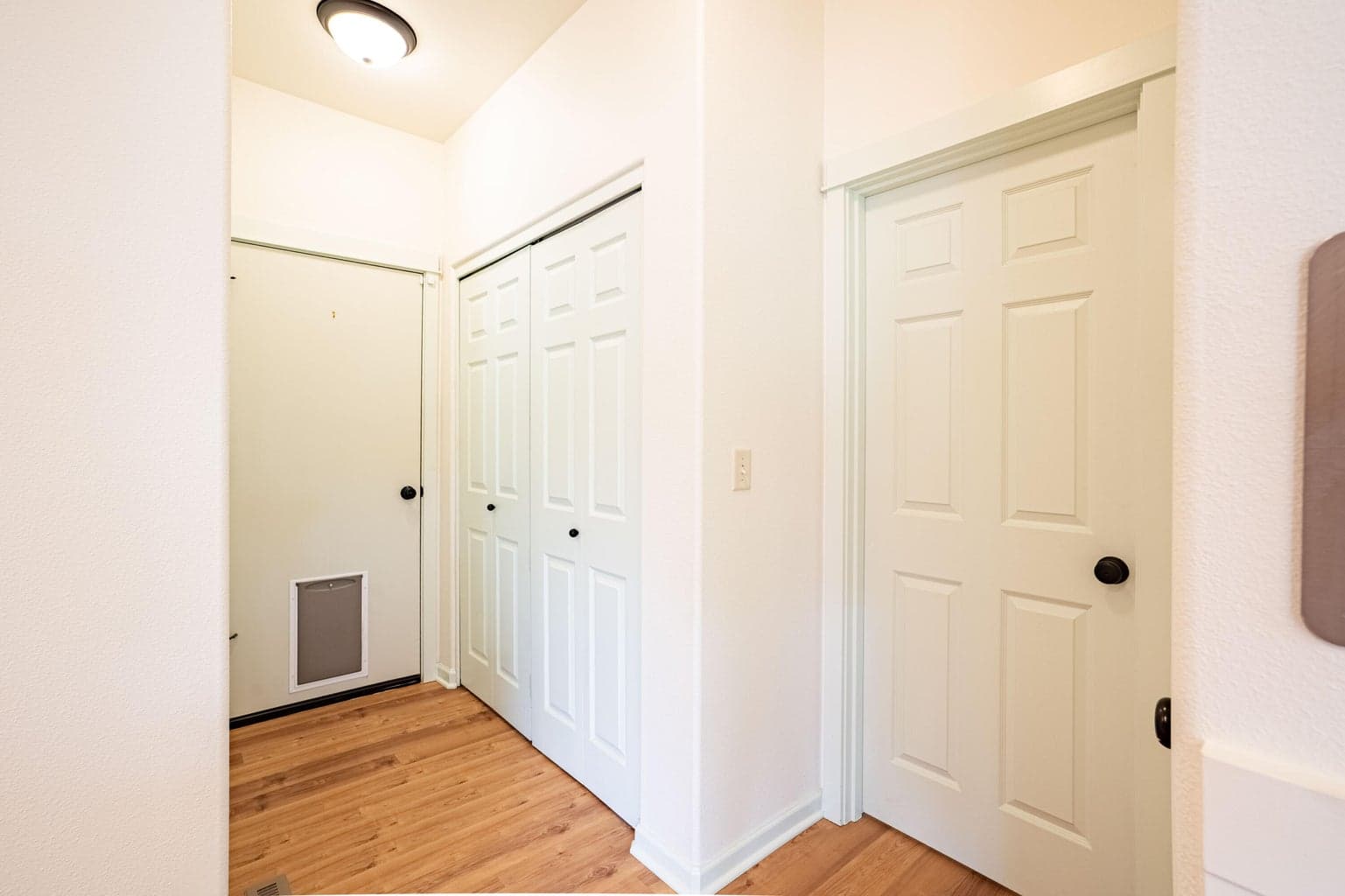 Garage, Laundry Closet, Powder Room and Entry to Primary Bedroom to the RIght