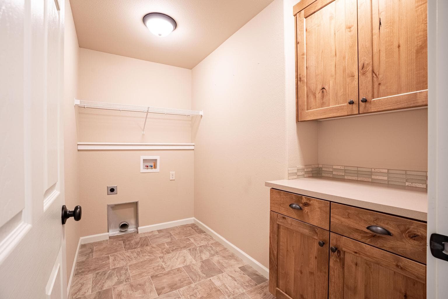 Laundry Room with folding counter and cabinet storage
