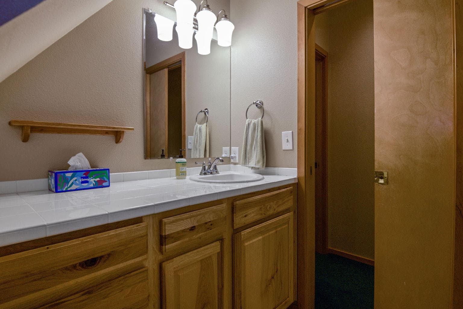 This bathroom is located on the second level, between two bedrooms