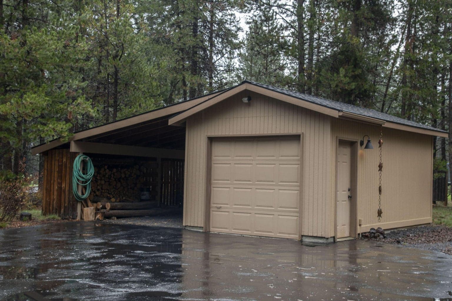 But wait, there's more! A one car garage and carport with tons of wood storage space, too!
