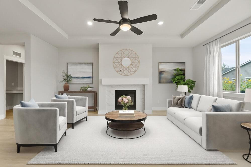 Great room with large windows, gas fireplace, coffered ceiling. This photo has been virtually staged.