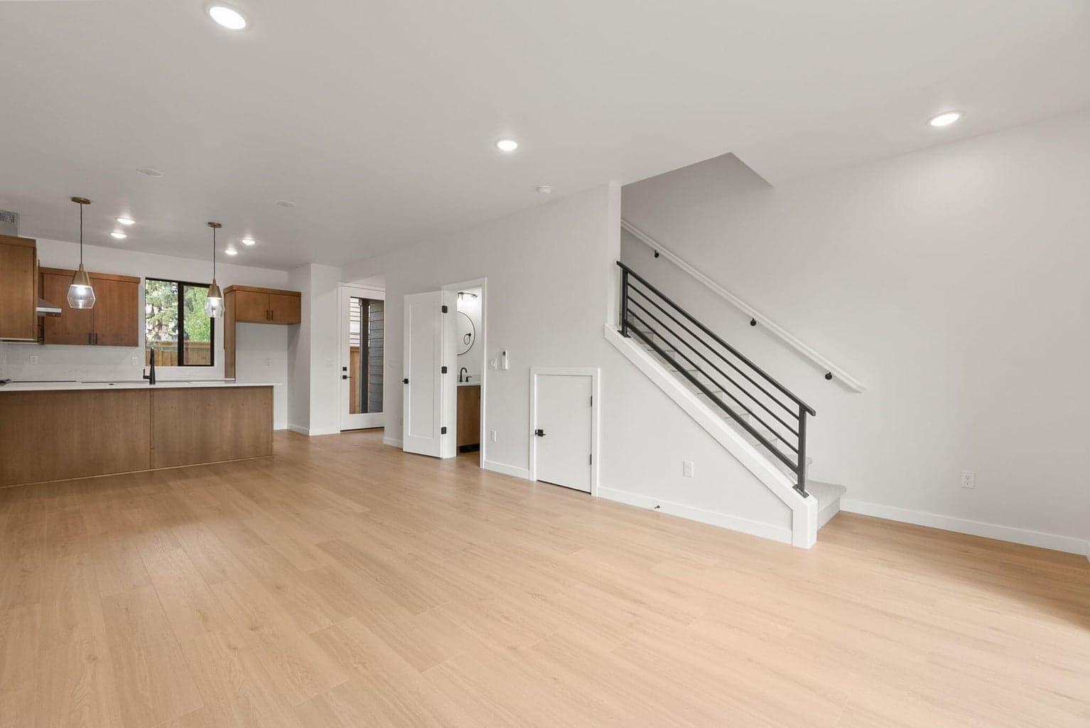 Main level half bath and extra storage underneath stairs.