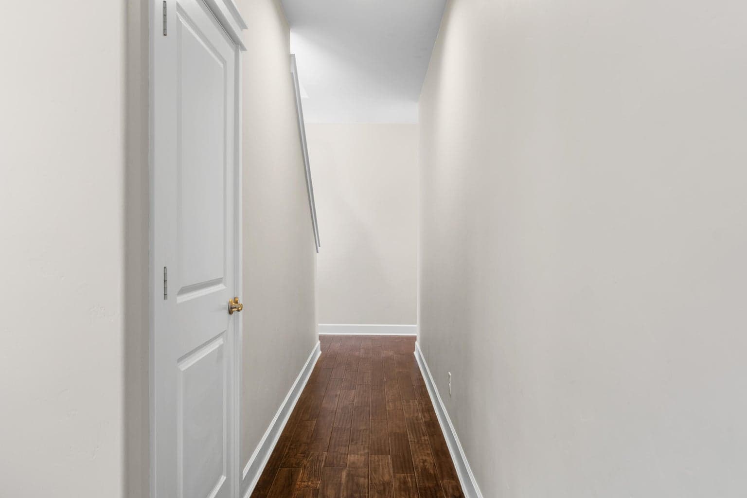 Hallway behind kitchen leading to upstairs