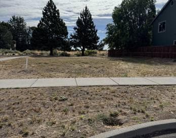 street view of the corner lot with utilities