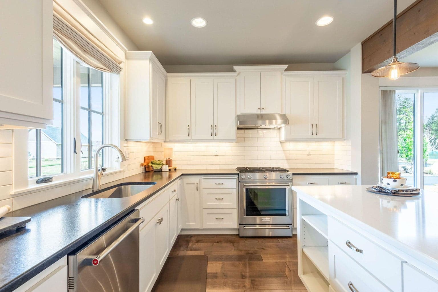 Chef’s kitchen with stainless appliances, double ovens, island seating & abundant cabinetry with pull-out drawers.
