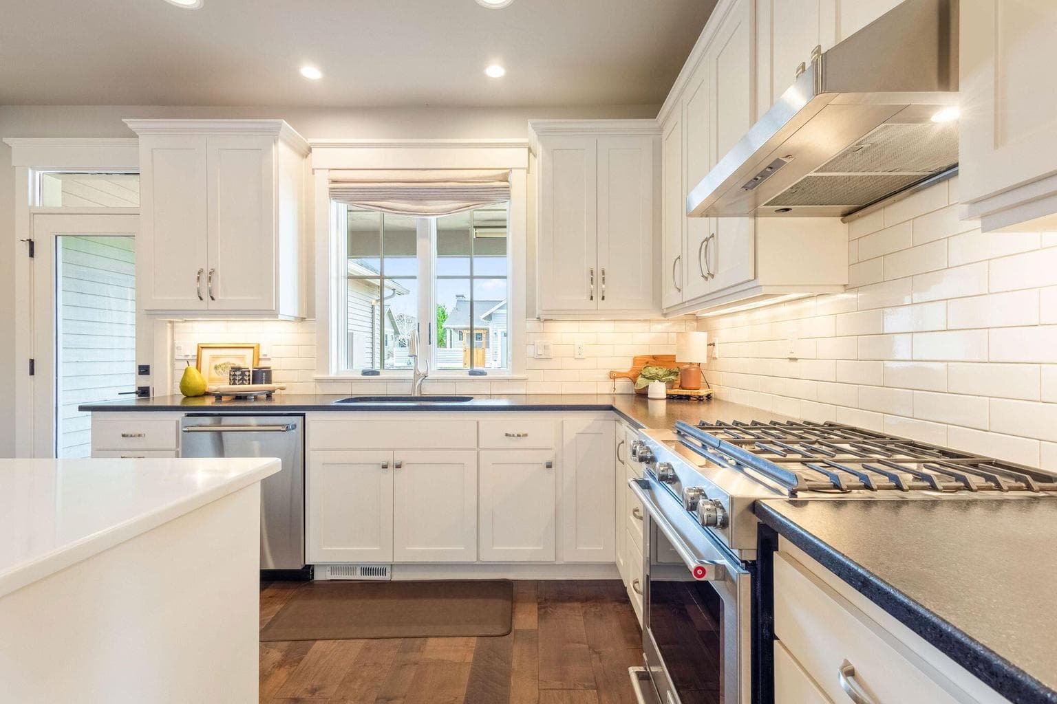 Chef’s kitchen with stainless appliances, double ovens, island seating & abundant cabinetry with pull-out drawers.