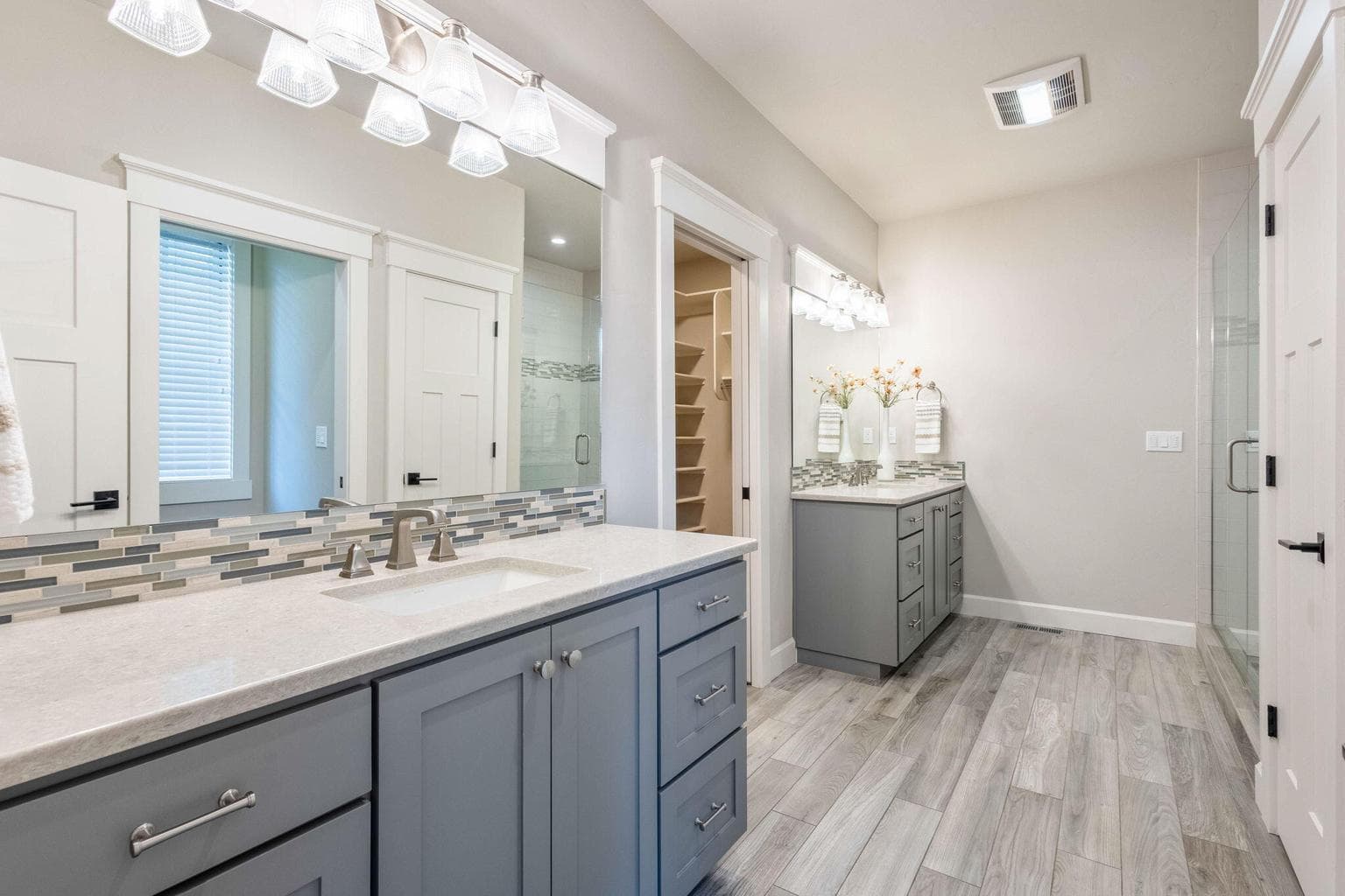 Dual vanity, tile/glass shower, heat lamp & walk-in closet with custom built-ins