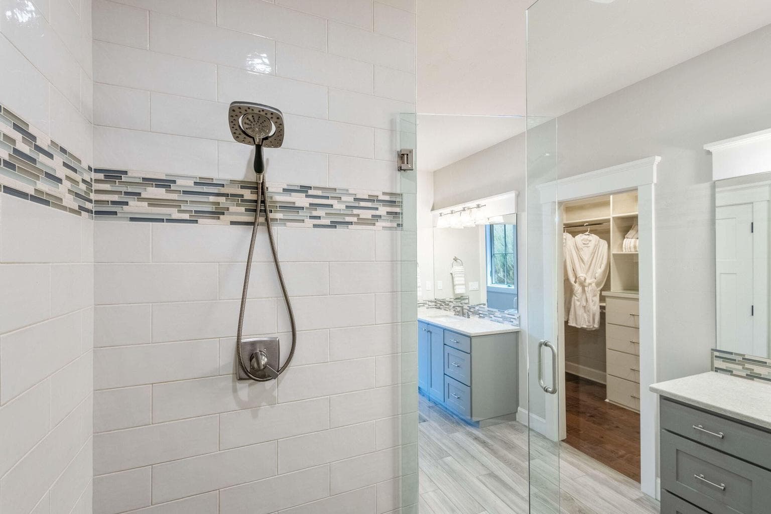 Dual vanity, tile/glass shower, heat lamp & walk-in closet with custom built-ins