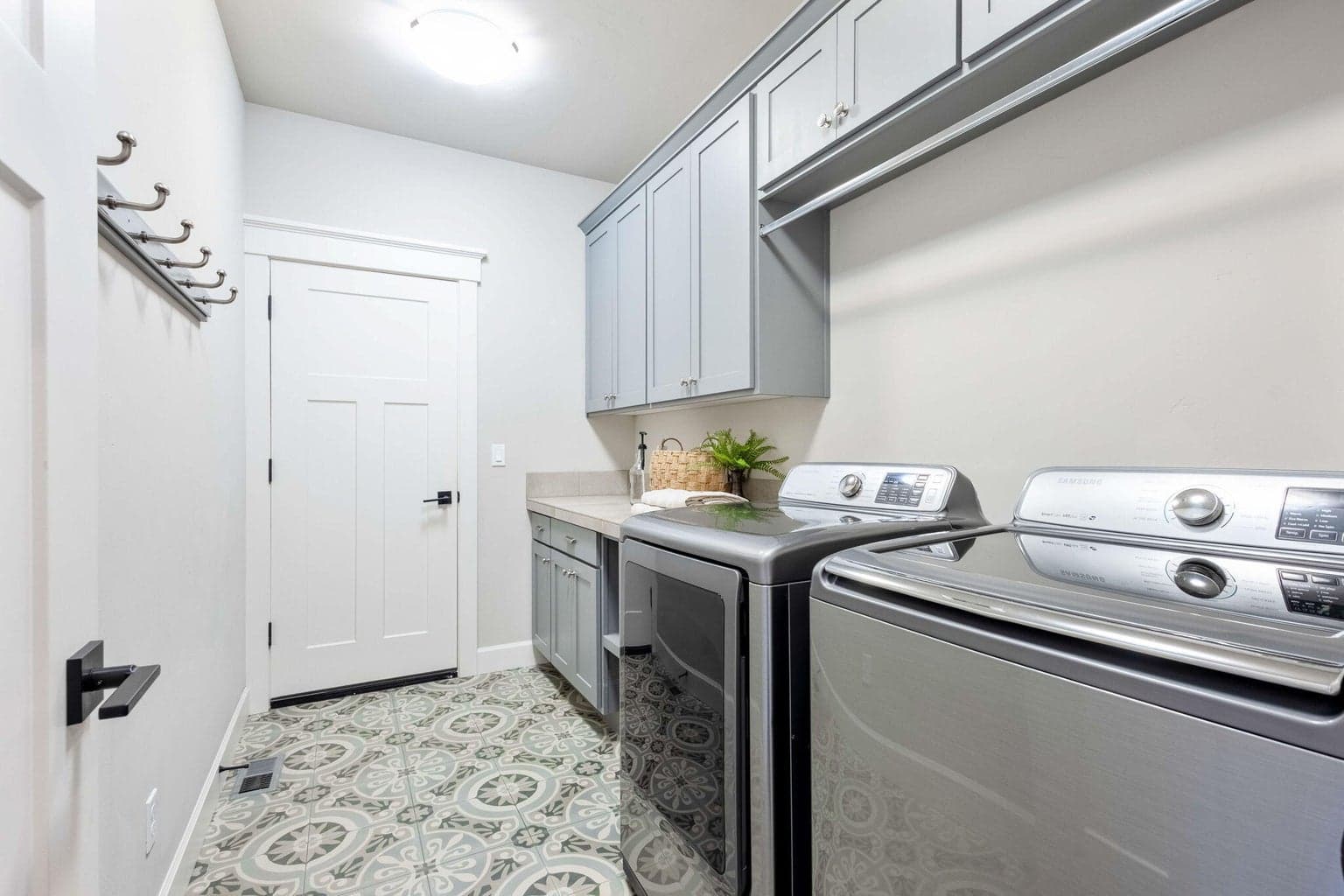 Generously appointed laundry room with built-ins and sink.