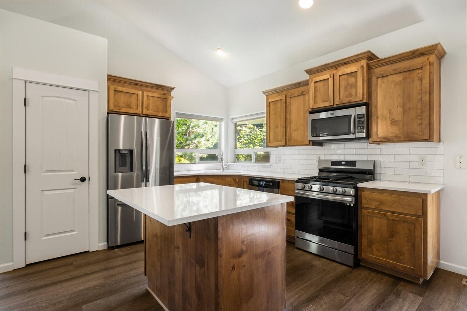 Wood cabinetry, quartz counters, stainless steel appliances & pantry