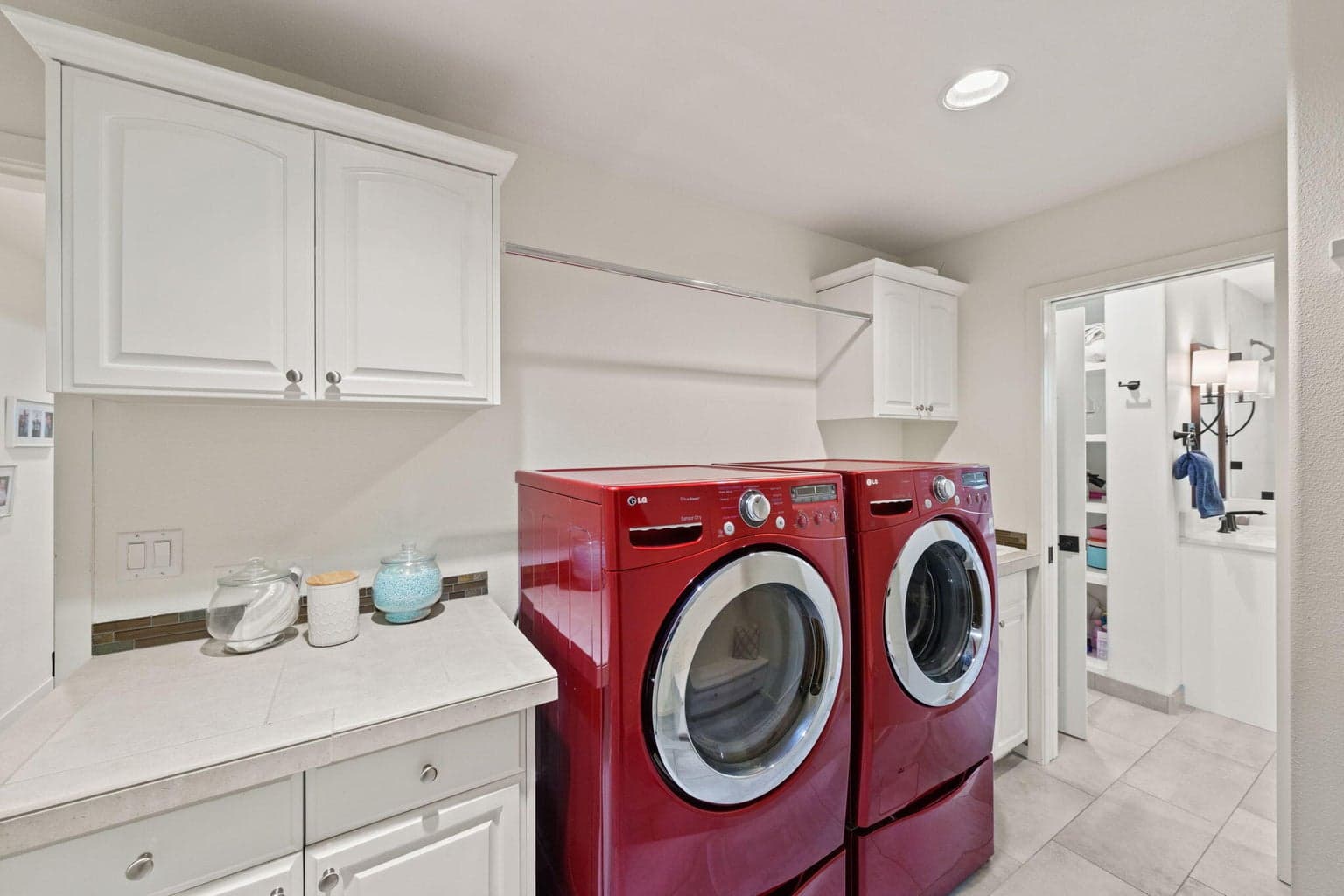 Laundry/Mudroom adjacent to entry from garage. Epoxy garage floors/cabinet storage