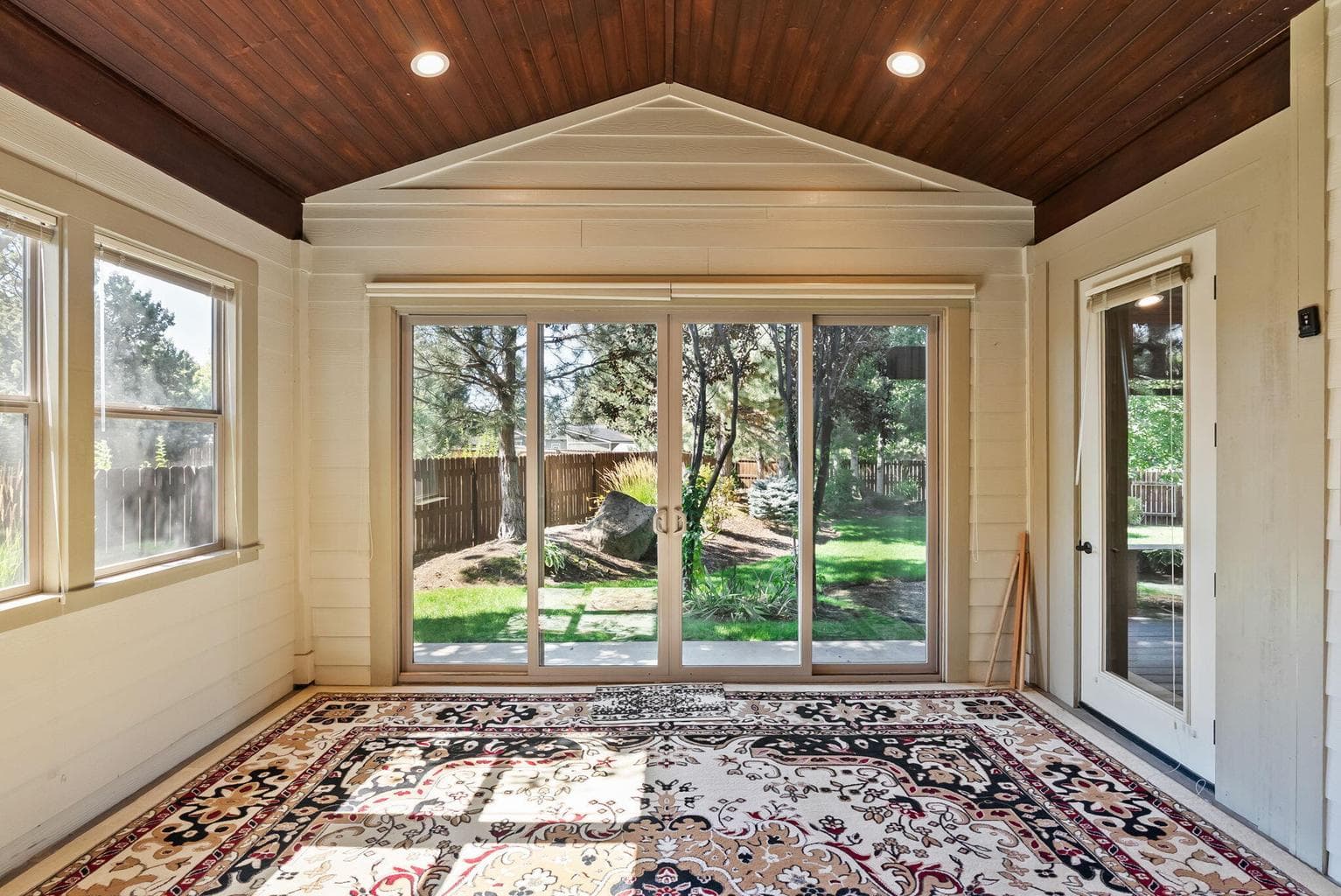 Enclosed porch/sunroom off primary suite with double sliders to backyard
