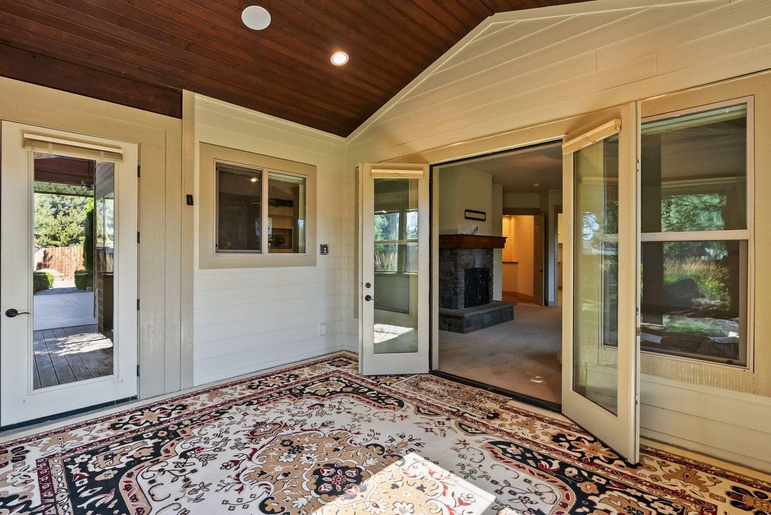 Enclosed porch/sunroom off primary suite with french door to covered back patio