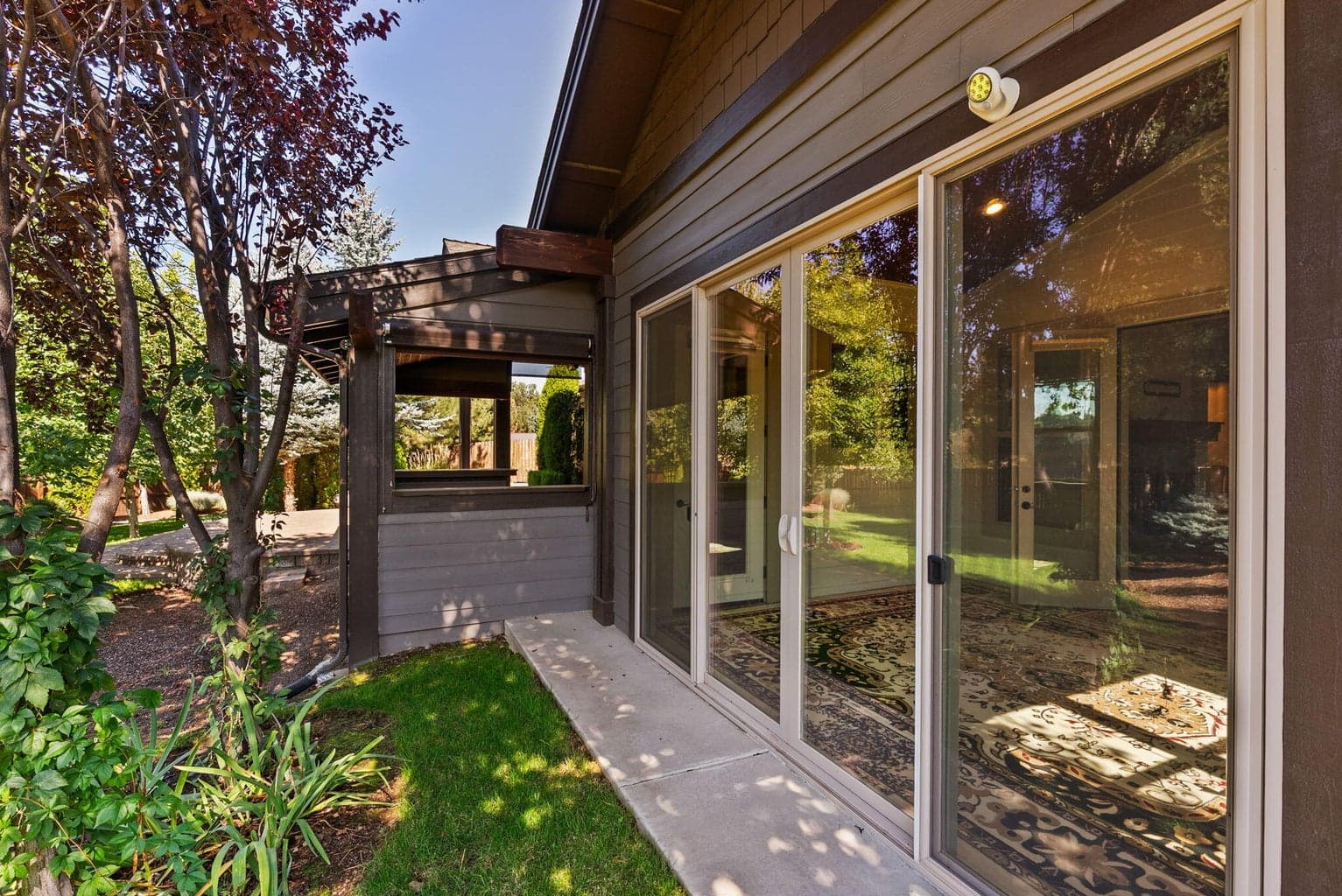 Double sliders off of primary suite sunroom/enclosed porch