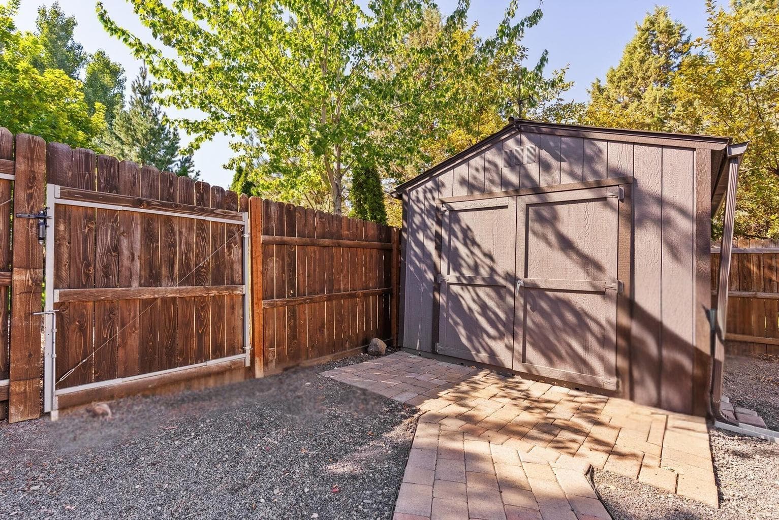 Storage shed with gate into back yard