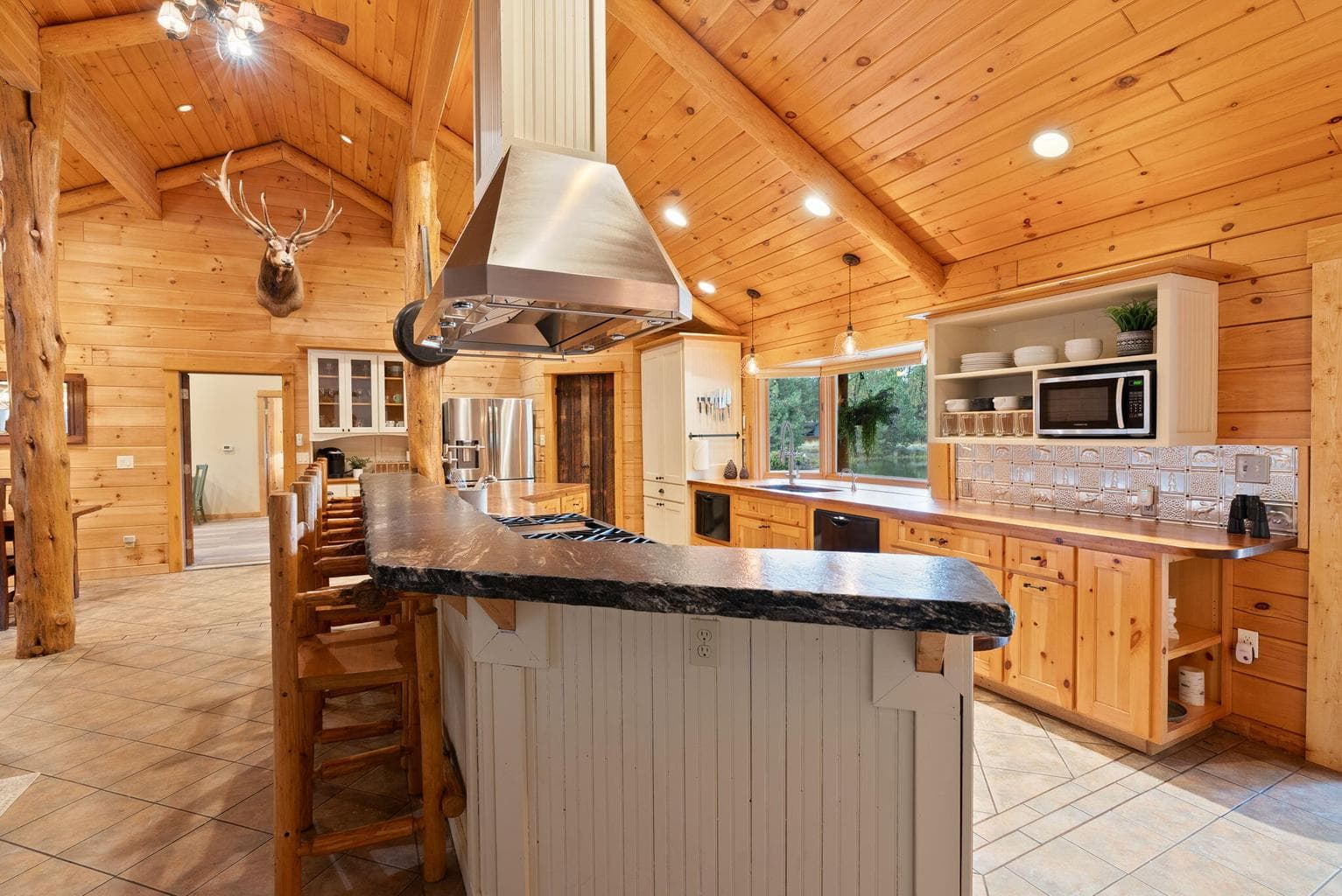 Spacious and fully-equipped Chef's Kitchen with stainless appliances, 2 dishwashers, walk-in pantry and multiple areas for dining.