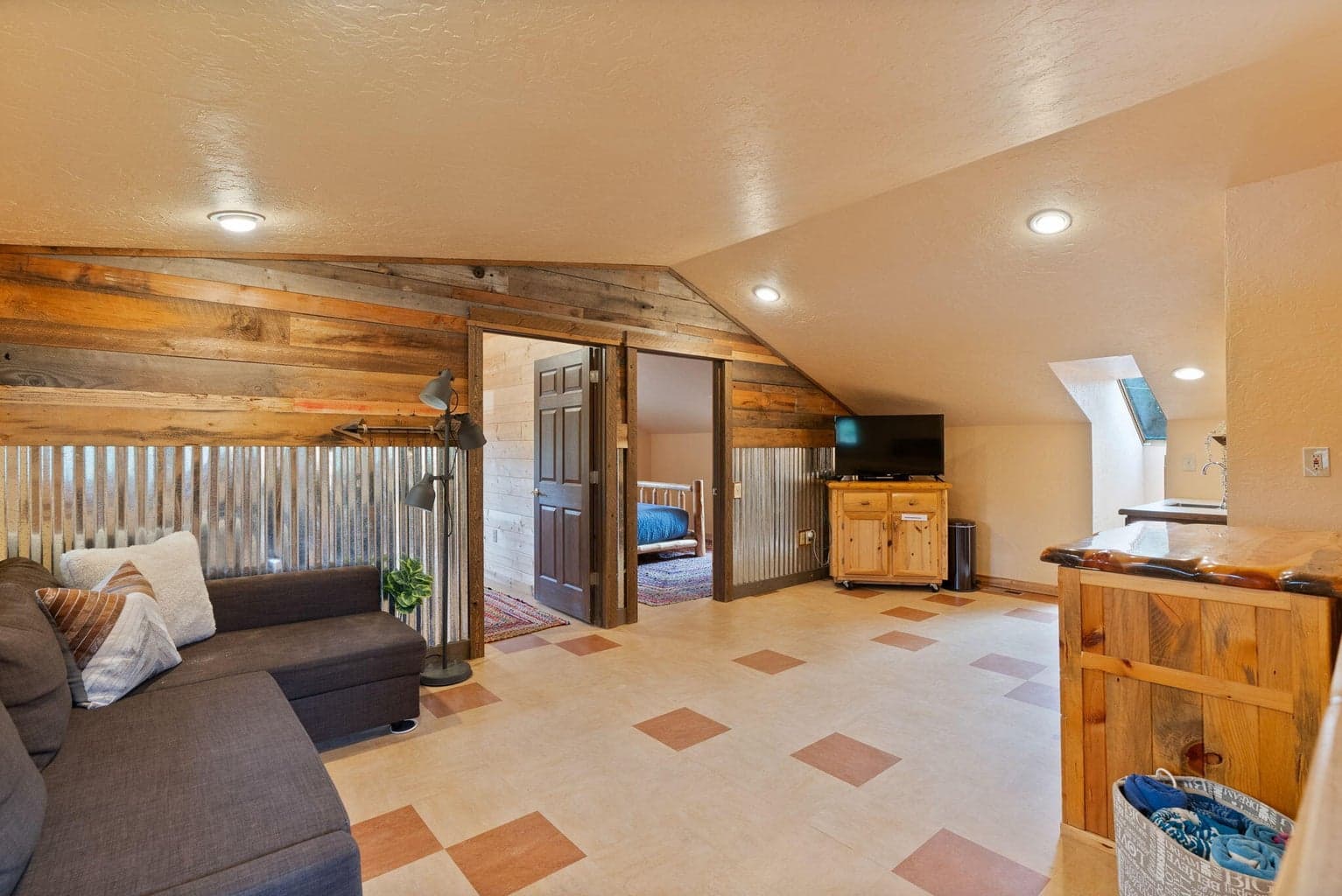 Located above the garage, the upper suite offers a living area, full bath and 2 bedrooms.