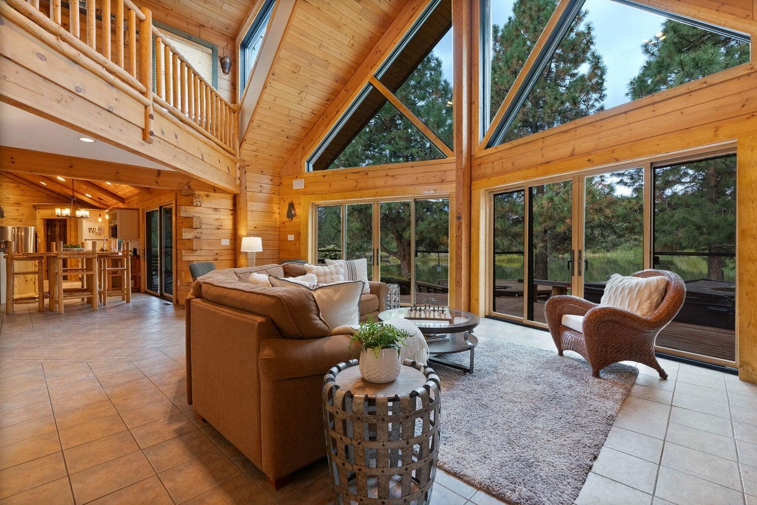 An exquisite light-filled Great Room featuring pine tongue and groove vaulted ceilings, wood burning fireplace and endless views.