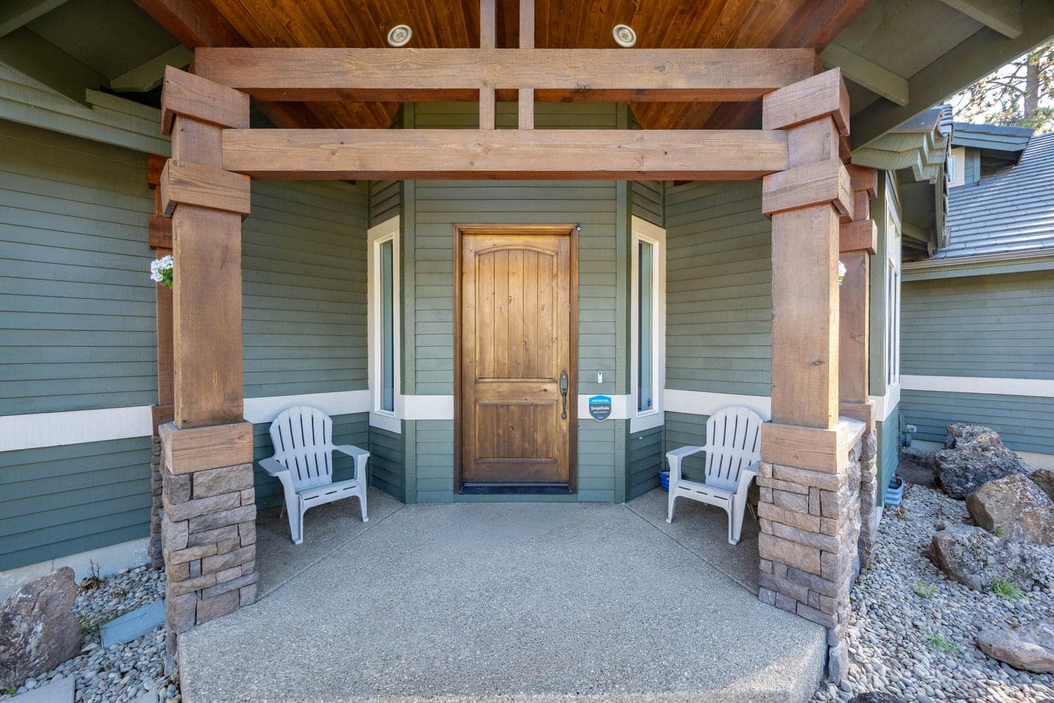 Covered front porch with wood beams and pillars, together with stone accents shows the quality of these well built townhomes