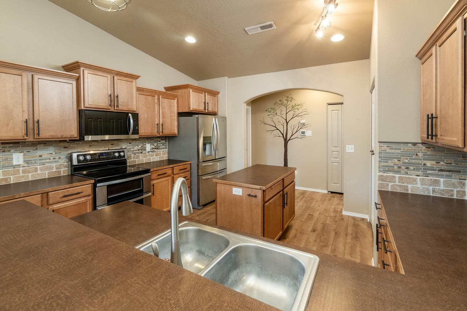 Amazing practical kitchen with stainless appliances, double sink, island, breakfast bar, pantry