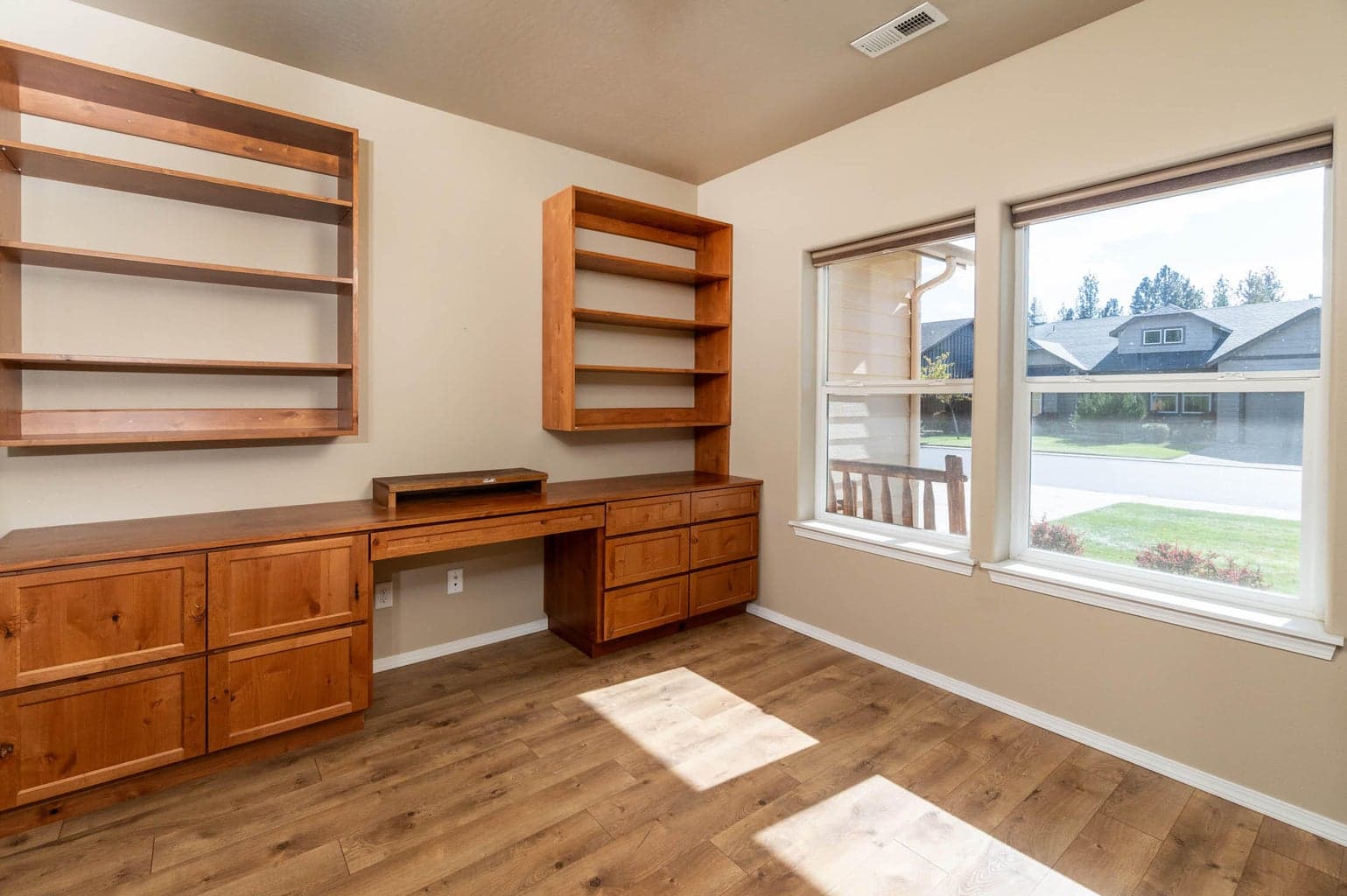 Front bedroom #1 with built-in desk and shelves, closet and french doors. Could be wonderful office/den