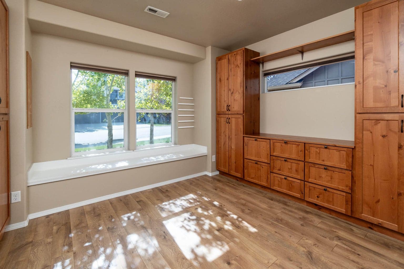 Front bedroom #2, amazing built-in desk, built-in cabinets, shelving inn the closet, window seat with dual windows. Perfect for craft/sewing room