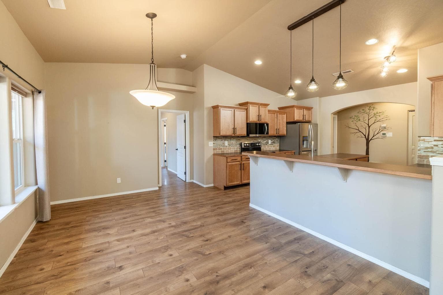 Eating area with nice windows with view of back deck. Breakfast bar with view of the large kitchen.