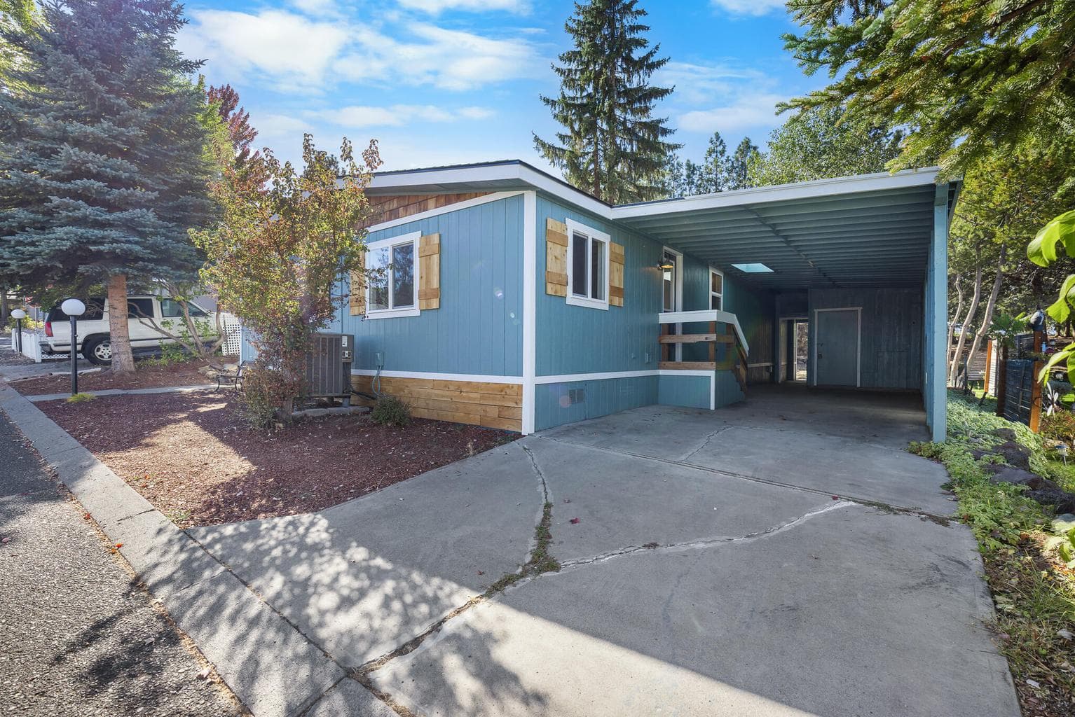Carport has large storage unit.
