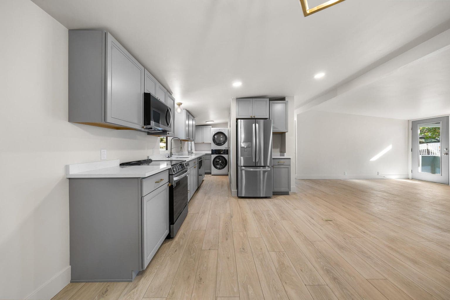 Kitchen has all new stainless steel appliances, laundry area has a counter for folding, stackable washer and dryer included.