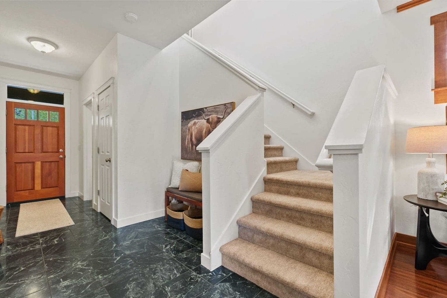 Front entry with half bath, green marble tiled entry, under-stair storage closet