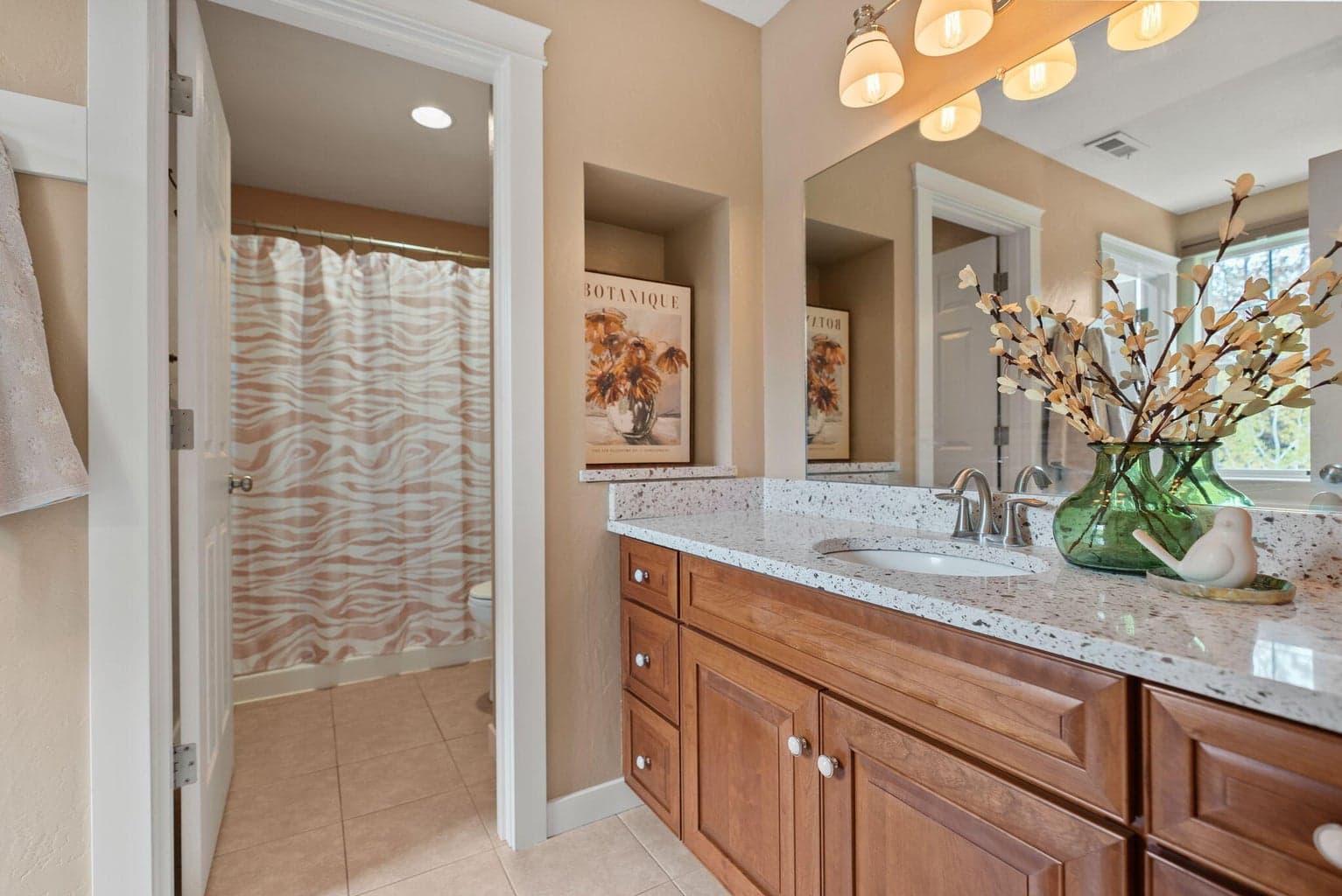 Upstairs primary suite with 2 walk-in closets, 2 vanities, and a separate commode and shower/tub