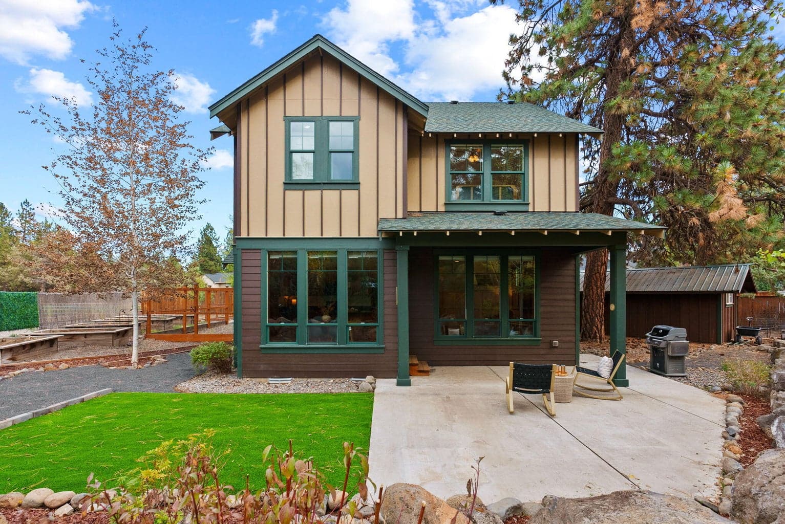 Perfect for outdoor living and hobbies is the fenced yard featuring the 180 SF shed, separate greenhouse, raised garden beds with a drip system, and a covered patio.