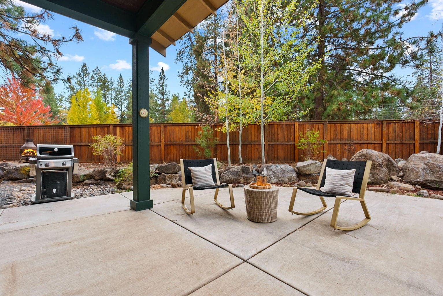 Perfect for outdoor living and hobbies is the fenced yard featuring the 180 SF shed, separate greenhouse, raised garden beds with a drip system, and a covered patio.