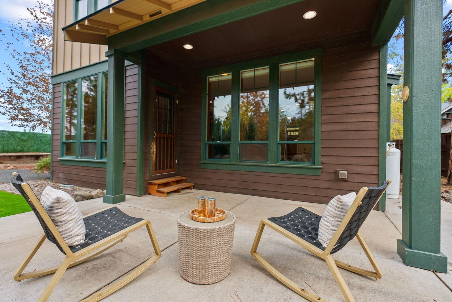 Perfect for outdoor living and hobbies is the fenced yard featuring the 180 SF shed, separate greenhouse, raised garden beds with a drip system, and a covered patio.