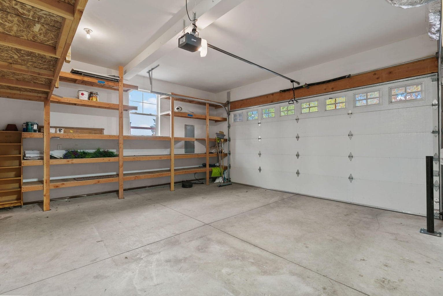 2-Car attached garage with 2 walls of built-in storage