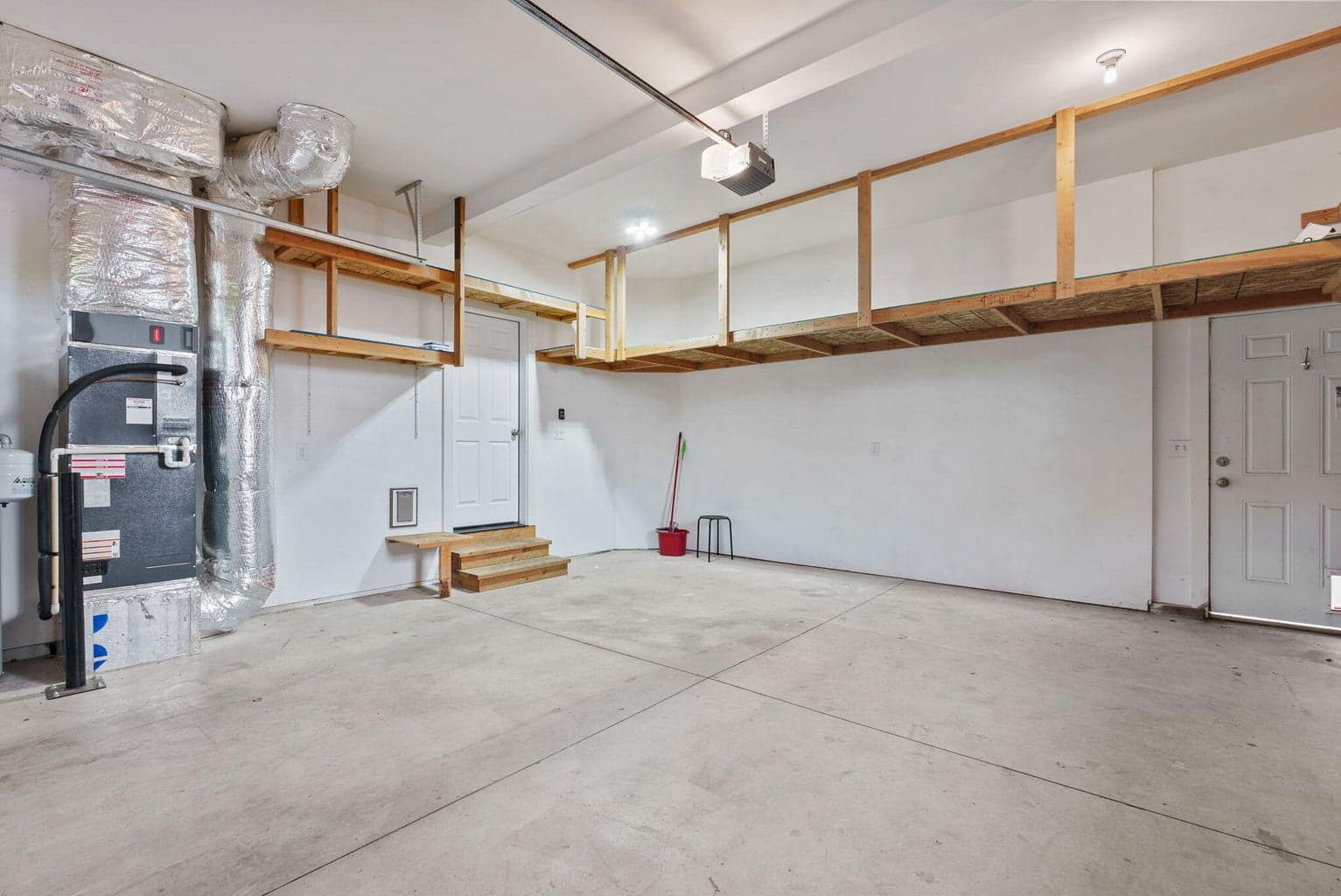 2-Car attached garage with 2 walls of built-in storage