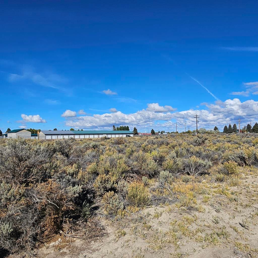 Looking across adjacent lot and Old lake Rd to the Storage facility. Mostly level lot with good visibility.