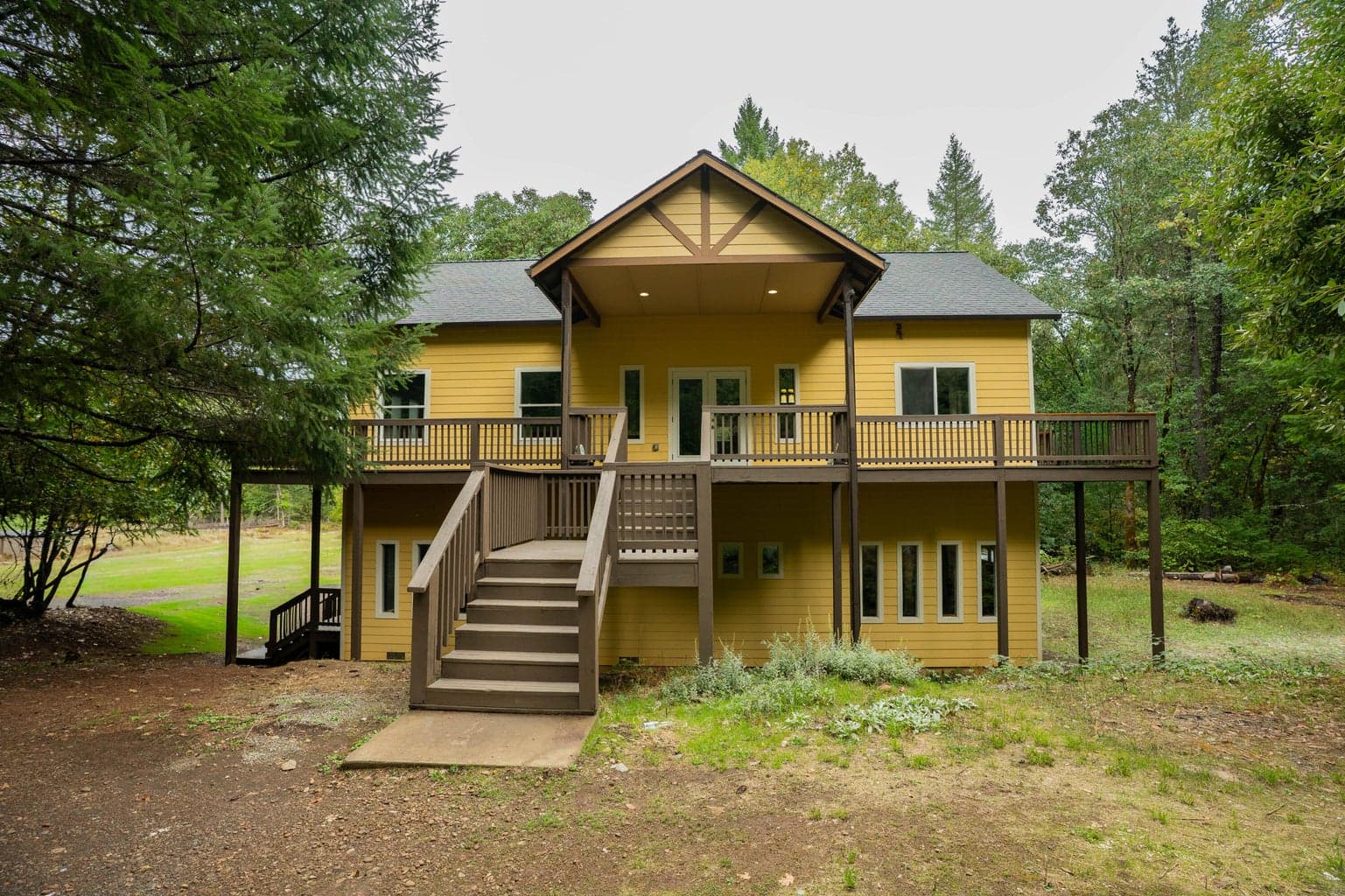 Charming craftsman-style home with an inviting wraparound deck that perfectly blends indoor comfort with outdoor living.