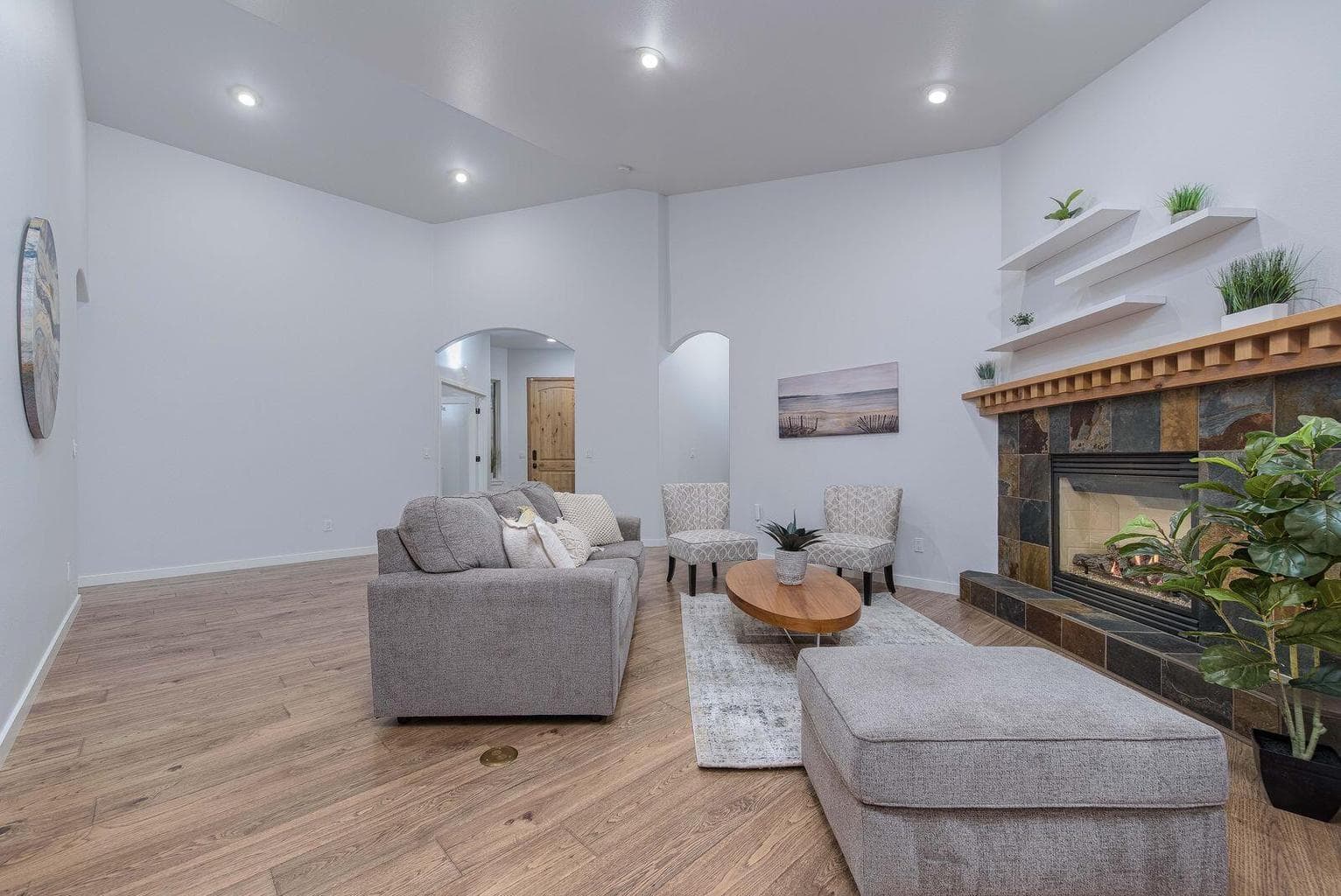 Great room with beautiful engineered wood floors and a cozy gas fireplace. The home lives like a single level with two ensuites and an office all on the main floor.
