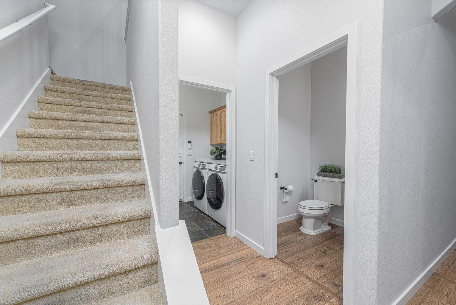 Stairs to the upper level with a 3rd guest suite and loft space