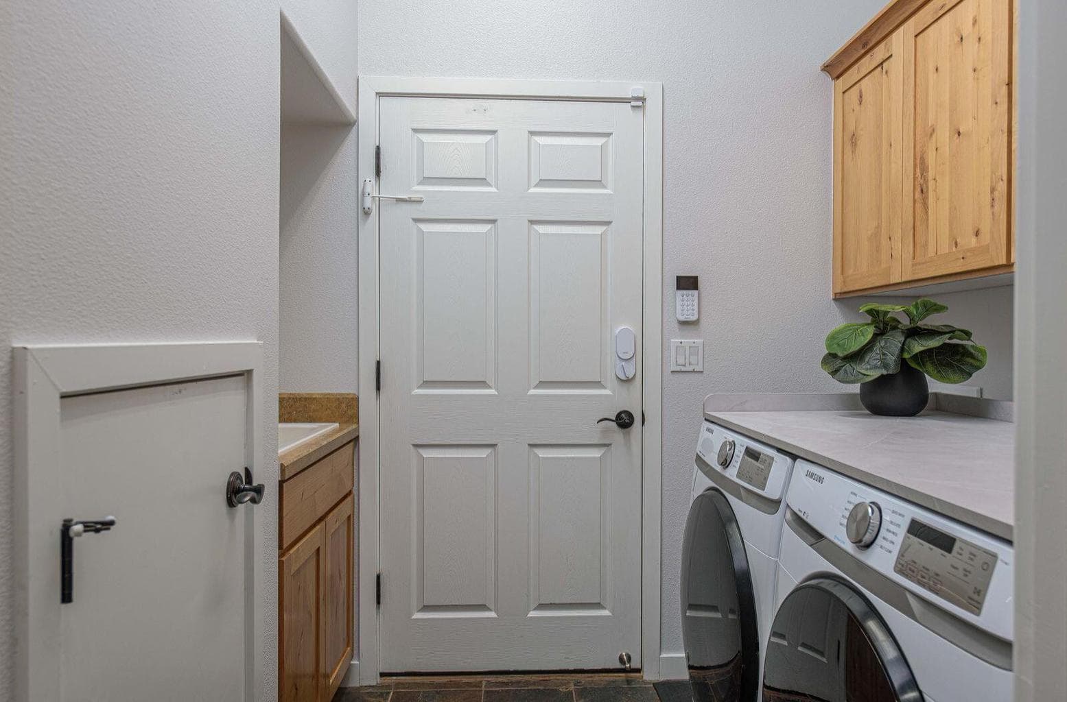Laundry room with new washer/dryer, utility sink and lots of storage